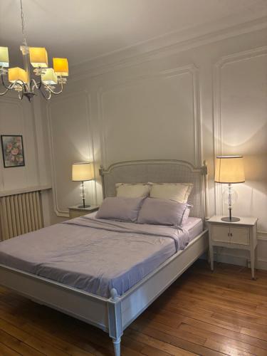 une chambre avec un lit avec deux lampes sur deux tables dans l'établissement 3 bedroom Eiffel Tower Apartment, à Paris