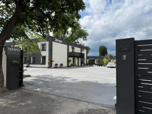a building with a sign in front of a parking lot at Tempo Boutique in Buzau
