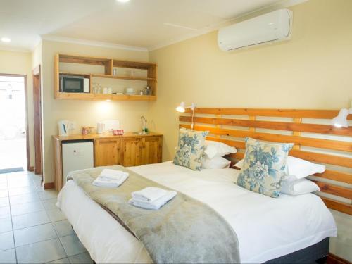 a bedroom with two beds with towels on top of them at Nobis House Annex in Bloemfontein