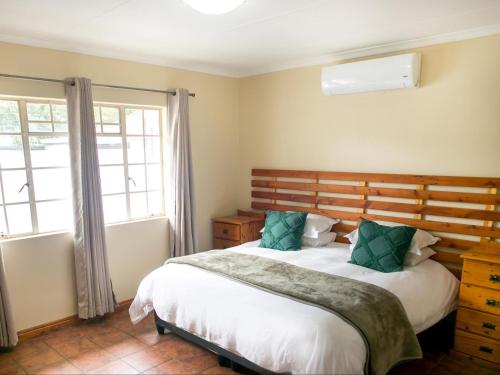a bedroom with a large bed and a window at Nobis House Annex in Bloemfontein