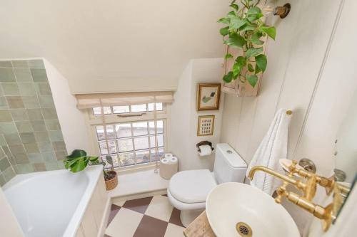 a bathroom with a sink and a toilet and a tub at The Nook - Stylish Homestay - Heart of Frome in Frome