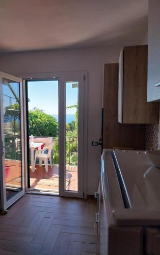 a kitchen with a sliding glass door to a patio at Villa Arianna Tropea in Tropea