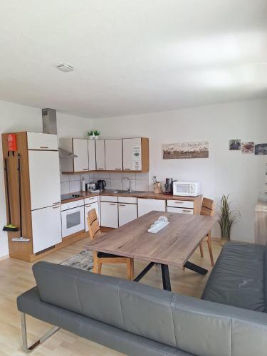 a living room with a table and a kitchen at Haus Matthias in Umhausen