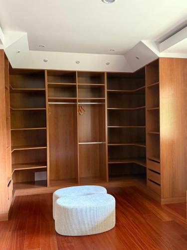 a room with wooden closets and a white ottoman at Le Grand Hôtel Le Touquet-Paris-Plage in Le Touquet-Paris-Plage
