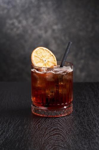 a drink with an orange slice on a table at Kaunas in Kaunas