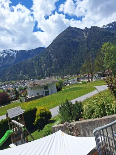 a view of a house with mountains in the background at Haus Matthias in Umhausen
