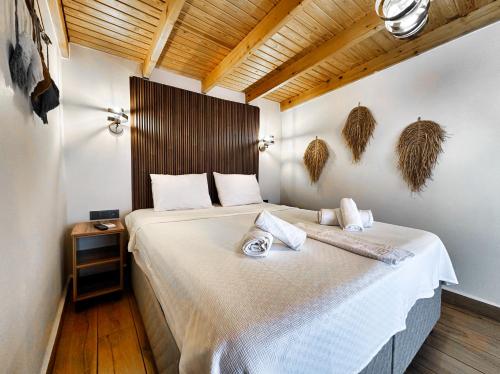 a bedroom with a large bed in a room at Tinos Otel & Bağ Evi 12 Yaş Üstü in Bozcaada