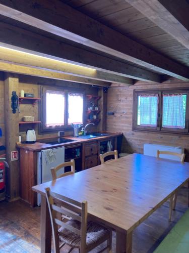 a kitchen with a large wooden table and chairs at La BAITA in Roccabruna