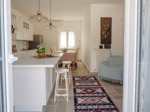 a kitchen and living room with a table and chairs at Casa Pietra Bianca Fay in Castellana Grotte