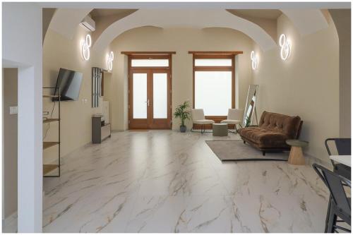 a large living room with a couch and a television at Piave X Design Loft Quadrilatero WiFi AC in Turin