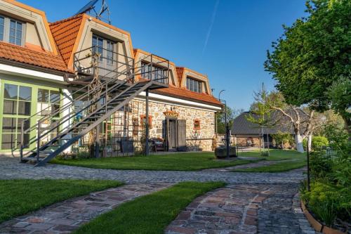 a house with a staircase on the side of it at DVOR 13 Hokovce in Hokovce