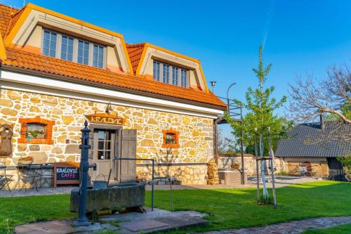 a large stone building with an orange roof at DVOR 13 Hokovce in Hokovce