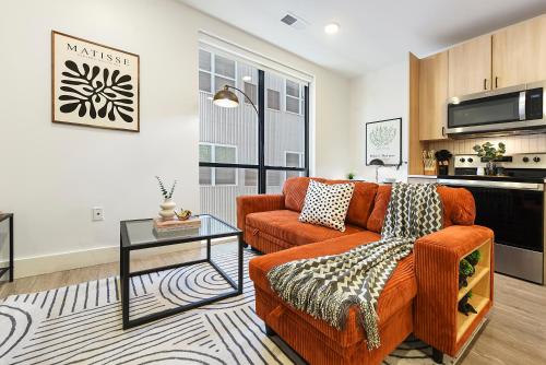 a living room with a couch and a table at LUX Studio King Bed Gym Free Parking in Pittsburgh