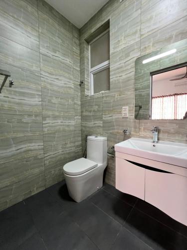 a bathroom with a toilet and a sink at Sea View Apartment in Colombo