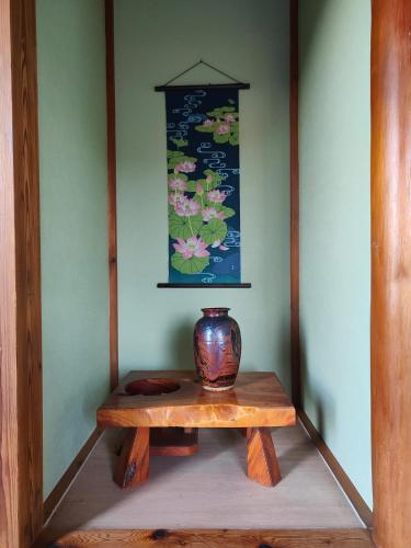 a vase sitting on top of a wooden table at 8 minutes by walk to Nikko Station Mitsuba House in Nikko