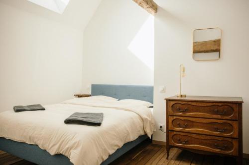 a bedroom with a bed and a wooden dresser at Pied à Terre in Bain-de-Bretagne