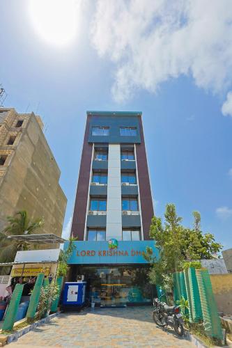 a tall building with a sign in front of it at The Castle Crown - Hotel Lord Krishna Dham in Dwarka