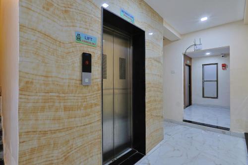 an elevator in a building with a door in the wall at The Castle Crown - Hotel Lord Krishna Dham in Dwarka