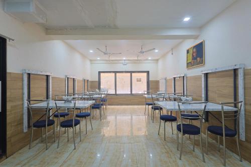a row of tables and chairs in a room at The Castle Crown - Hotel Lord Krishna Dham in Dwarka