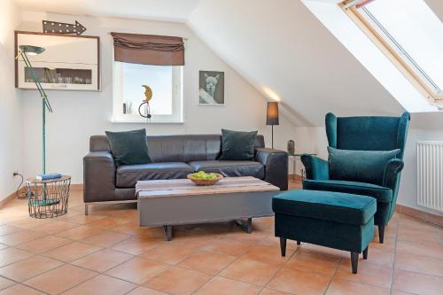 a living room with a couch and two chairs at Arne's Koje in Fehmarn
