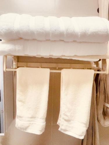 two towels are hanging on a rack in a bathroom at 定安厝 Ding'an Village 位于百年历史建筑群 近西湖 河坊街 南宋御街 in Hangzhou
