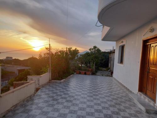 a view of a balcony of a house with the sunset at Paulino's Apartments in Lukovë