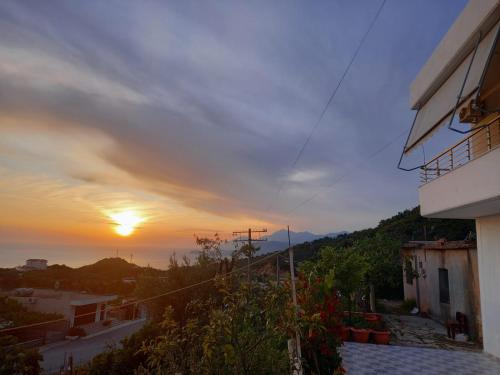 a view of the sunset from a balcony of a house at Paulino's Apartments in Lukovë