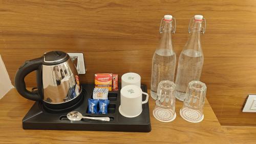 a coffee maker and two glass bottles on a table at Sundervan Vilas Ranthambore in Khilchipur