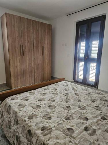 a bedroom with a bed and wooden cabinets at Tra Mare e Terra Reggio Calabria in Lazzaro