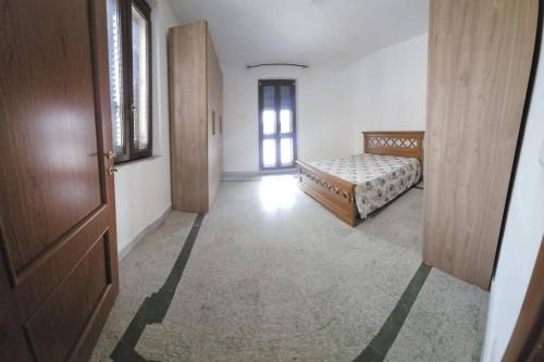 a hallway with a bedroom with a bed and a door at Tra Mare e Terra Reggio Calabria in Lazzaro