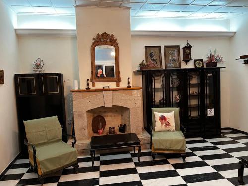 a living room with a fireplace and two chairs at Villa by the Sea, Nyfida Lesvos in Nifida