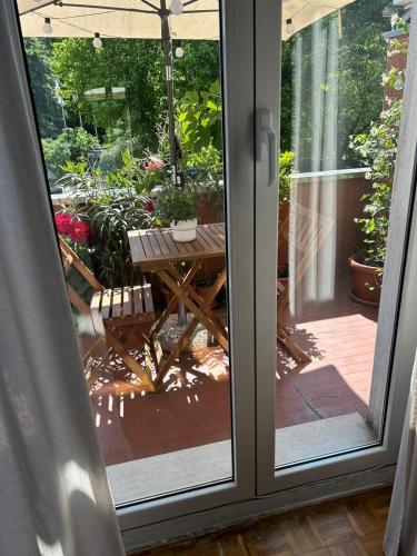 an open sliding glass door with a picnic table on a patio at Vito's Room in Cormano
