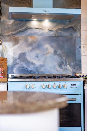 a stove top oven in a kitchen at Santa Cruz Surf House by Stoke Travel in A dos Cunhados