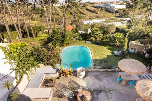 an aerial view of a backyard with a swimming pool at Santa Cruz Surf House by Stoke Travel in A dos Cunhados