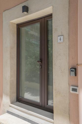 a glass door on the side of a building at Eos - Elegants Apartments & Suites in Siracusa