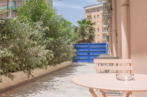 a white table and chairs on a balcony with plants at Eos - Elegants Apartments & Suites in Siracusa