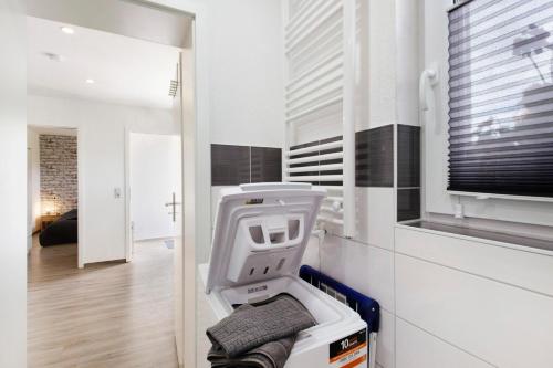 a white room with a machine in a room at Ferienwohnung Pfauenhof in Harztor