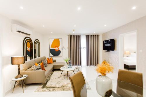 a living room with a couch and a table at Accra Luxury Apartments at Loxwood in Accra