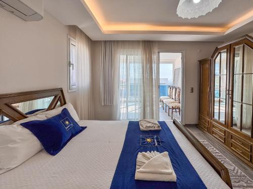a bedroom with a large bed with blue pillows at Villa Zeytin in Kusadası
