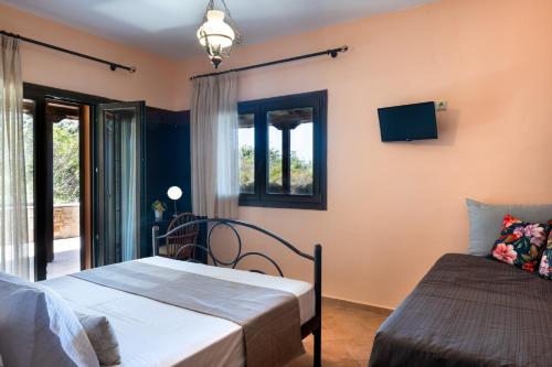 a bedroom with two beds and a window at Aether & Gaia Seaview Villas, Agios Nikolaos #FeelsLikeHome in Akti Salonikiou