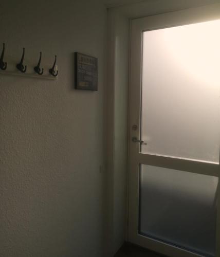 a room with a door with a window and a sign at HK Homes Apartments in Aarhus