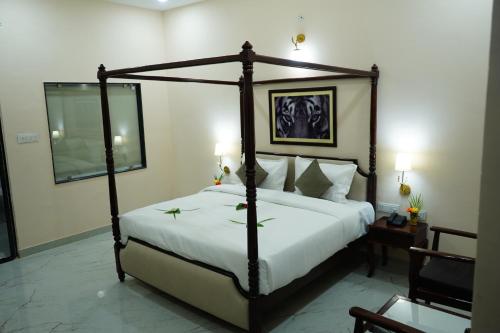 a bedroom with a large bed with a white bedspread at Sundervan Vilas Ranthambore in Khilchipur