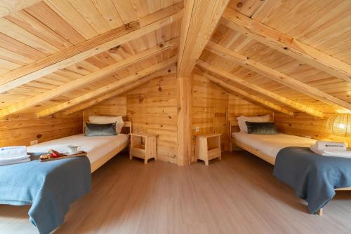 a room with two beds in a wooden house at HostWise - Quinta do Vintém w/ Terrace near WOW in Vila Nova de Gaia