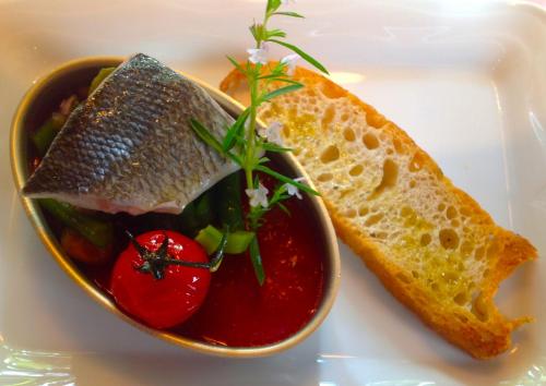 a bowl of food with bread and tomato sauce at Hotel Weinhaus Stern in Buergstadt