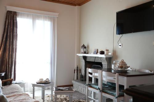 a living room with a fireplace and a tv on the wall at Boutique Arachova Retreat - Peaceful Mountain View in Arachova