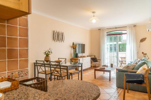 a living room with a couch and a table at LV Premier Troia in Troia