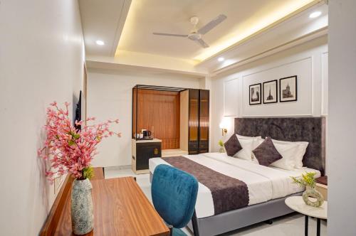 a hotel room with a bed and a table at Saltstayz Premier - Arjun Marg in Gurgaon