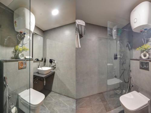 a bathroom with a shower and a toilet and a sink at Saltstayz Premier - Arjun Marg in Gurgaon