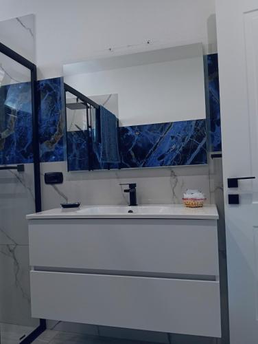a bathroom with a white sink and a mirror at Stella di mare - appartamenti vista incantevole su Moneglia in Moneglia