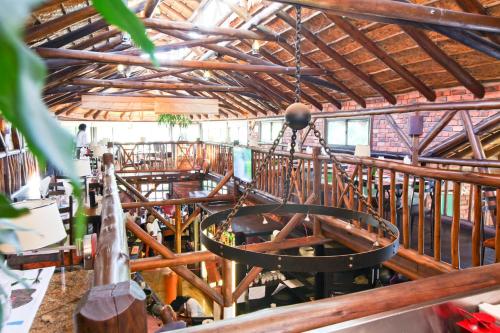 a large room with wooden beams and a largeiameterasteryasteryasteryasteryasteryastery at Roof of Africa Hotel in Windhoek